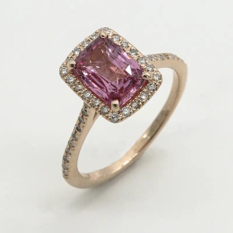Pink sapphire ring with diamond halo in rose gold