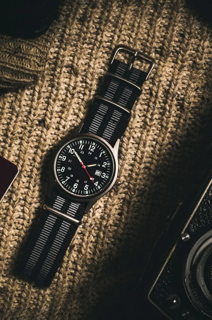 Striped grey and black NATO watch strap on wool knit