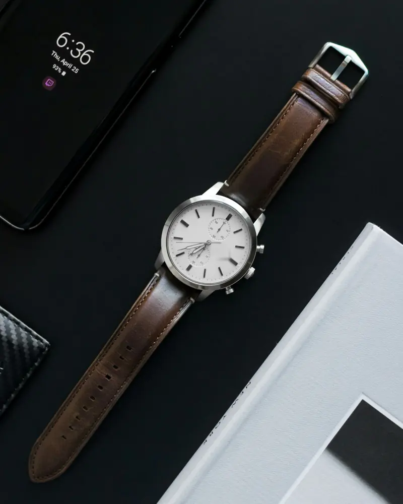 White-dial chronograph on brown leather strap against black
